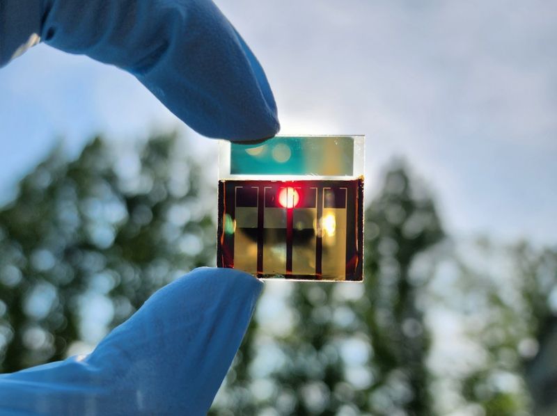 The newly developed Semi-transparent perovskite solar cell held up to the sunlight.