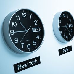 A row of clocks showing the time in different international cities, like New York and Paris.