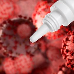 white dropper bottle in top right hand corner of image, against backdrop of red 3D-rendered coronaviruses