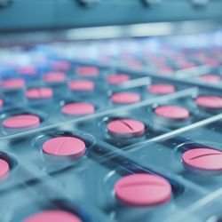 Macro Shot of Pink Pills During Production and Packing Process on Modern Pharmaceutical Factory. Medical Drug Manufacturing.