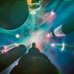 Several instruments are seen pointing towards a center where a bright light is forming