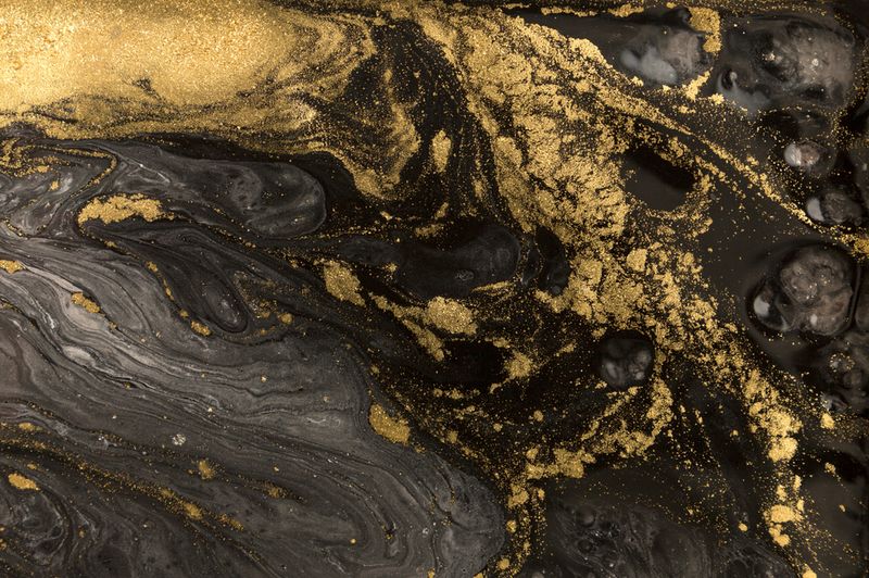 Marble abstract acrylic background of gold swirls against black water