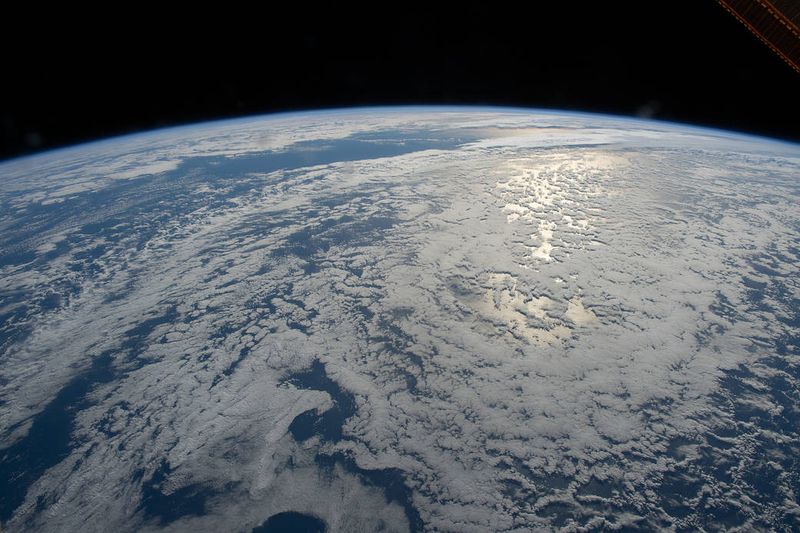 The sun's glint beams on the South Pacific Ocean as the International Space Station orbited just off the coast of New Zealand in July 2022.