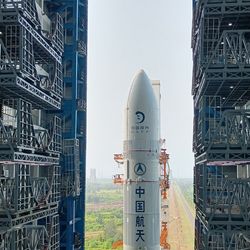 An image of the top part of a rocket leaving a building