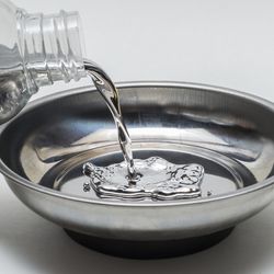 Pouring elemental mercury in a steel bowl