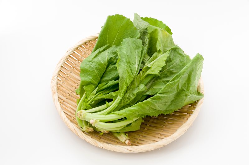 Mustard greens on a wooden plate