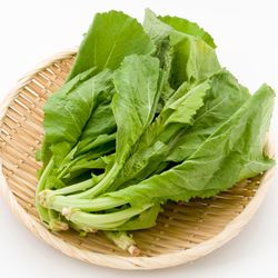 Mustard greens on a wooden plate