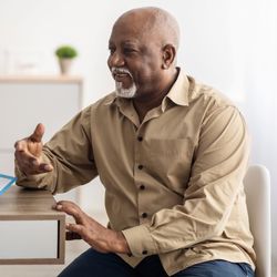 older adult man in medical consultation with younger female doctor