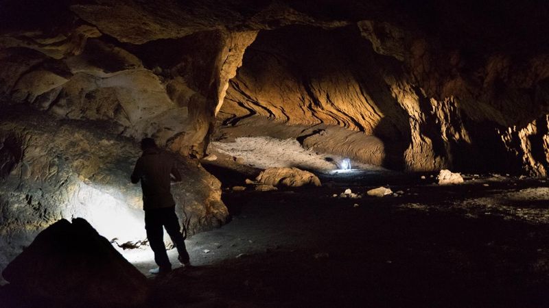 An archeologist in Pebdeh Cave, a prehistoric site located in present-day Iran among the southern Zagros Mountains was occupied by hunter-gatherers as early as 42,000 years ago.