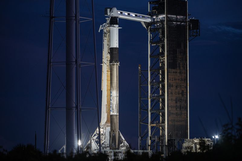 The rocket is seen at night on the launch pad. It is clear and well illumindated. 