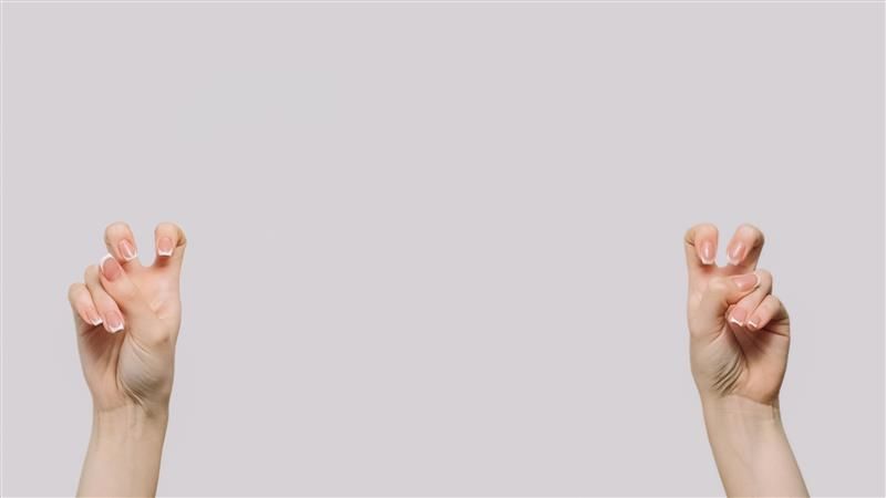 A photo of two hands doing "bunny ears" to indicate a sarcastic/ironic statement, set against a white background. 