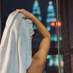 Woman in shower drying hair
