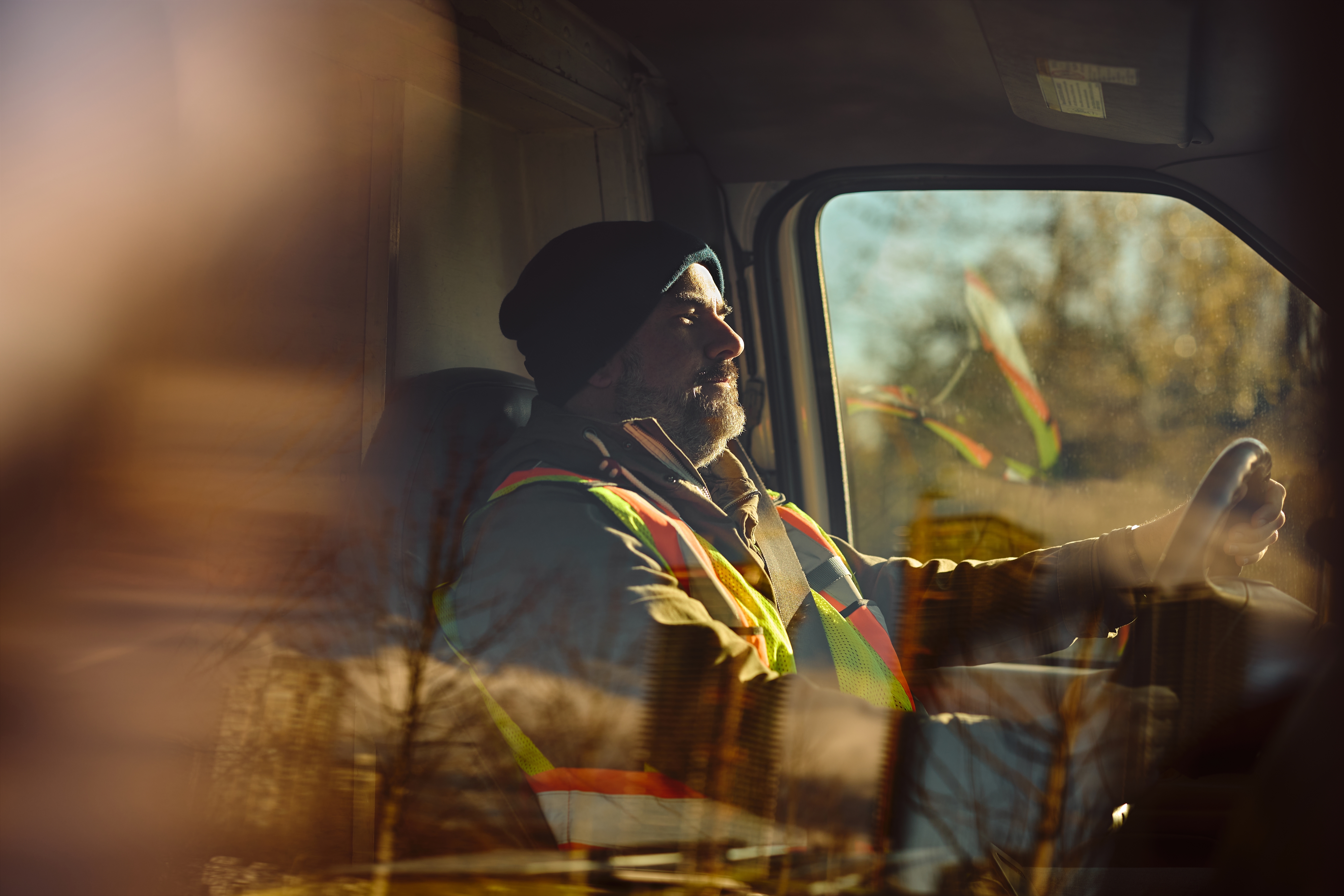 Male driver behind the steering wheel of a truck Male driver behind the steering wheel of a truck