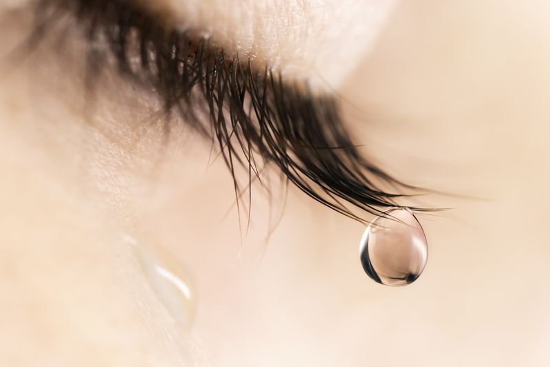 closeup of teardrop falling from someone's eye