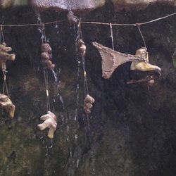 Teddy bears, underpants, and an ice skate hung up at the petrifying well