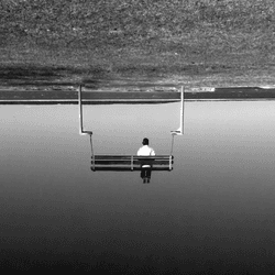 man sitting upside down on bench