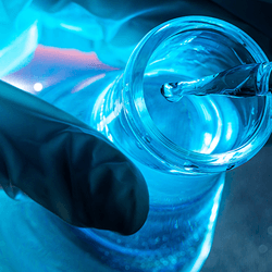 A flask containing a shiny blue liquid.