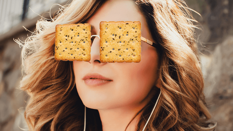 A woman wearing crackers instead of glasses.
