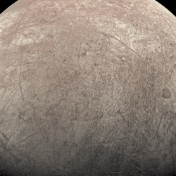 An image of Europa. Many groves are visible in the icy surface