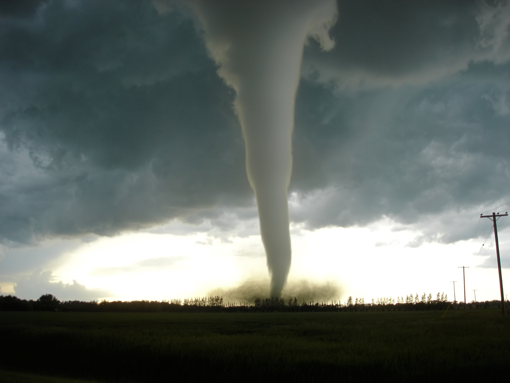a tornado cloud on a farm, the sky is dark a tornado cloud on a farm, the sky is dark