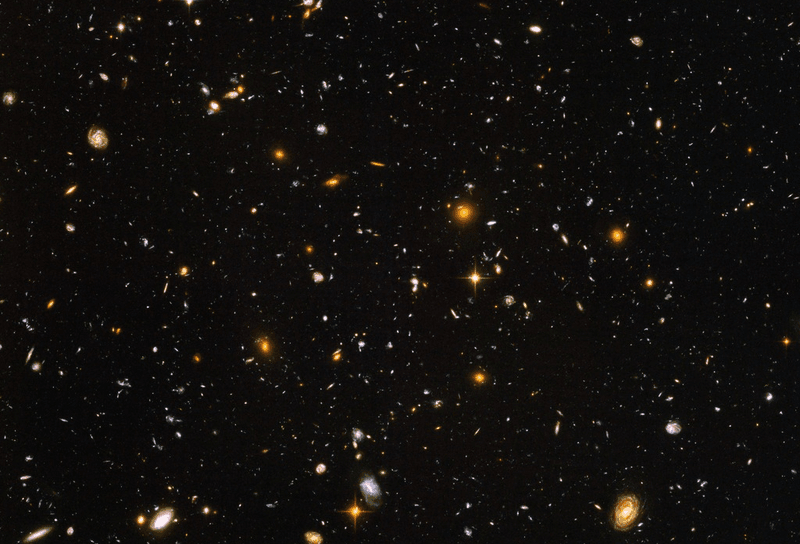 The Hubble deep field has helped trace the cosmic web that is arguably the most massive thing in the universe, as well as containing galaxies that represent more compact options
