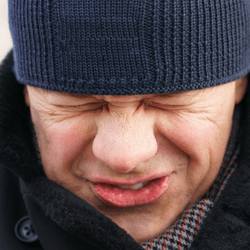 man trying to hold in a sneeze