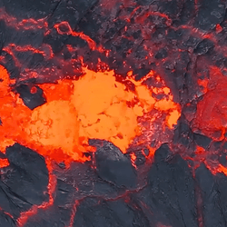 Close up drone shot of lava bubbling. Bright orange and red colors.
