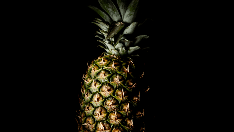 a pineapple on a black background