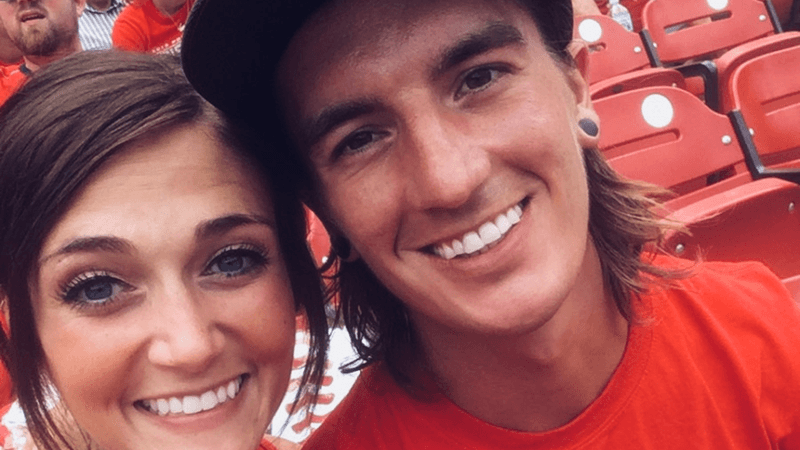 A young man and woman at a sports match.