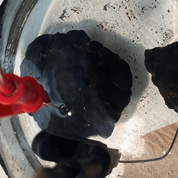 Polymetallic nodules, collected from the ocean floor, sit in simulated seawater in chemist Franz Geiger's laboratory to test their capacity to produce electricity and oxygenat Northwestern University