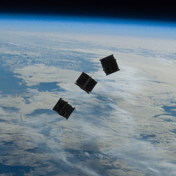 Three cubesats above Earth.