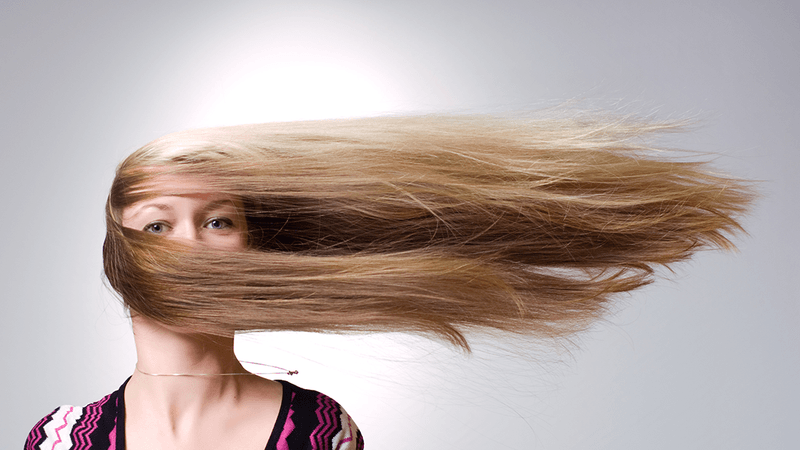 A woman with hair going sideways, rather than with gravity.