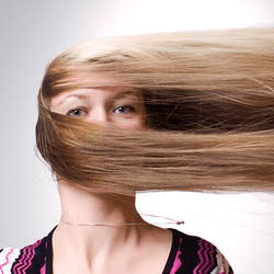 A woman with hair going sideways, rather than with gravity.