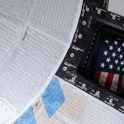 A photo of a portion of starliner showing in one of its windows the american flag