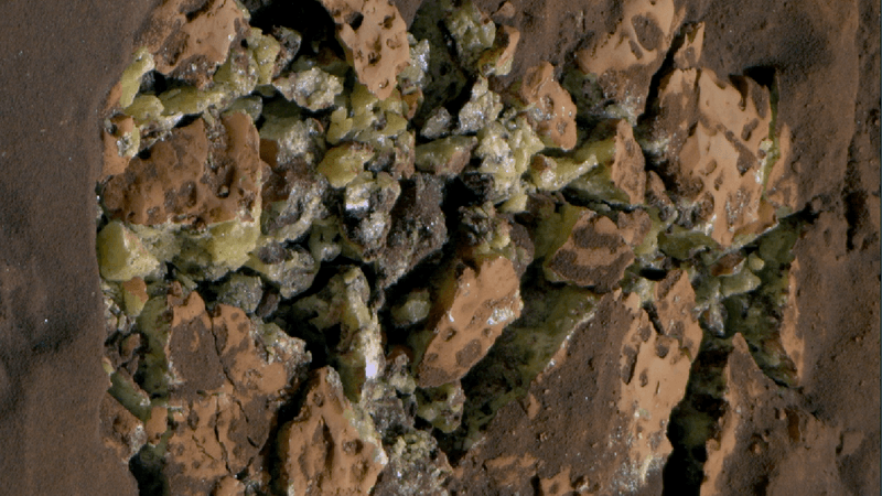 A cracked rock full of yellow crystals.