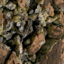 A cracked rock full of yellow crystals.