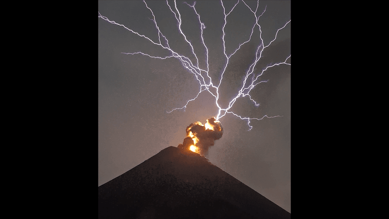Incredible series of lightning forks above the fire of an erupting volcano.