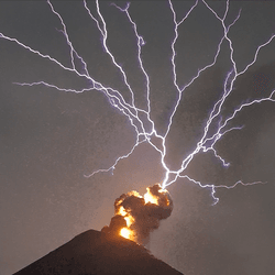 Incredible series of lightning forks above the fire of an erupting volcano.