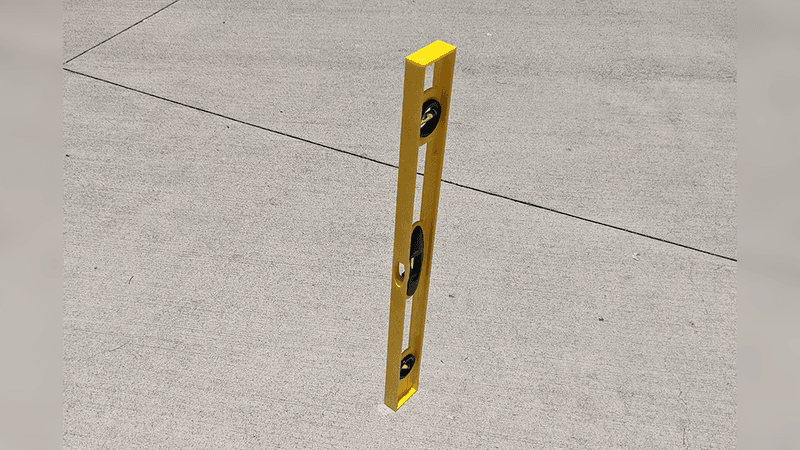 A level standing vertically and not casting a shadow